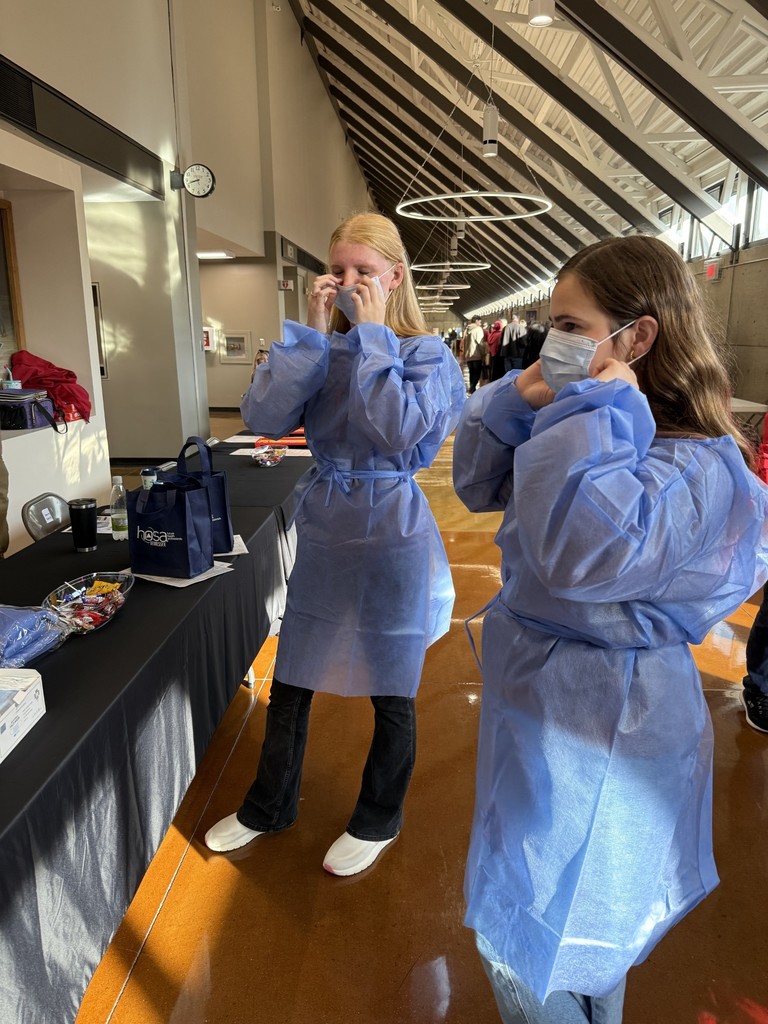 WCHS HOSA students attend The Discovery Summit and try on PPE. 