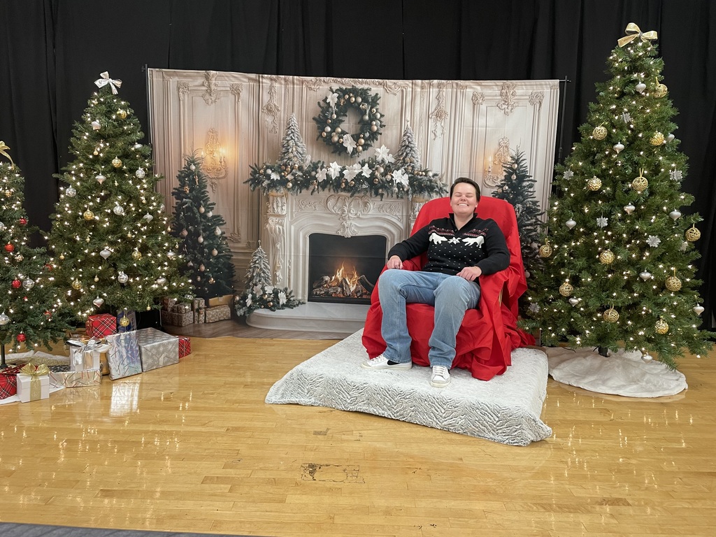 Emma O'Bryan - band director, pictured with christmas themed backdrop