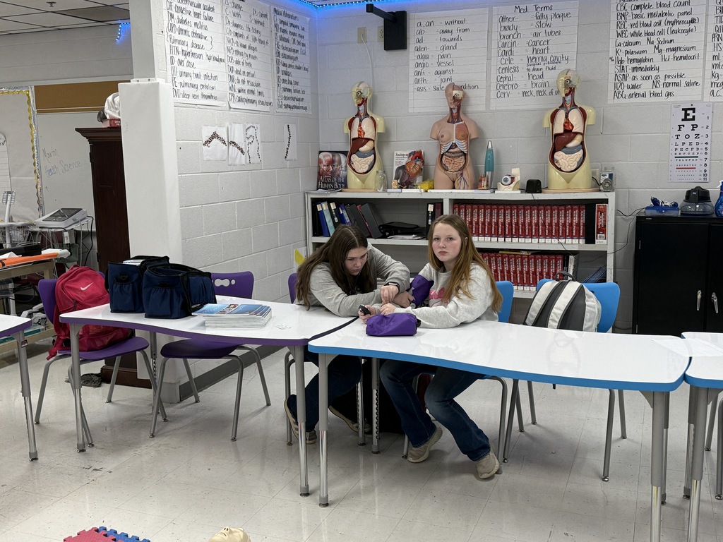 Health science students practicing taking vital signs 