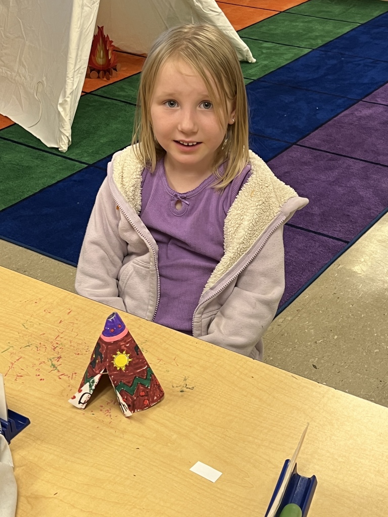 kindergarten students dressed as native americans in a tipi celebrating native american cultures
