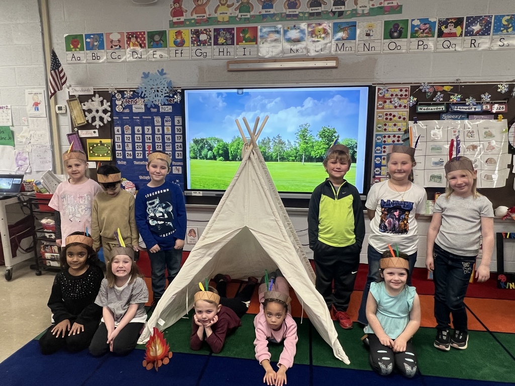 kindergarten students dressed as native americans in a tipi celebrating native american cultures
