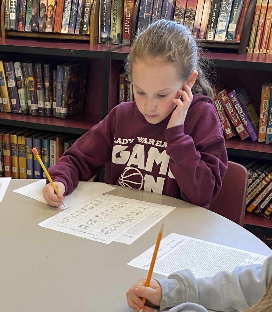 wces students practicing names like john hancock in the library