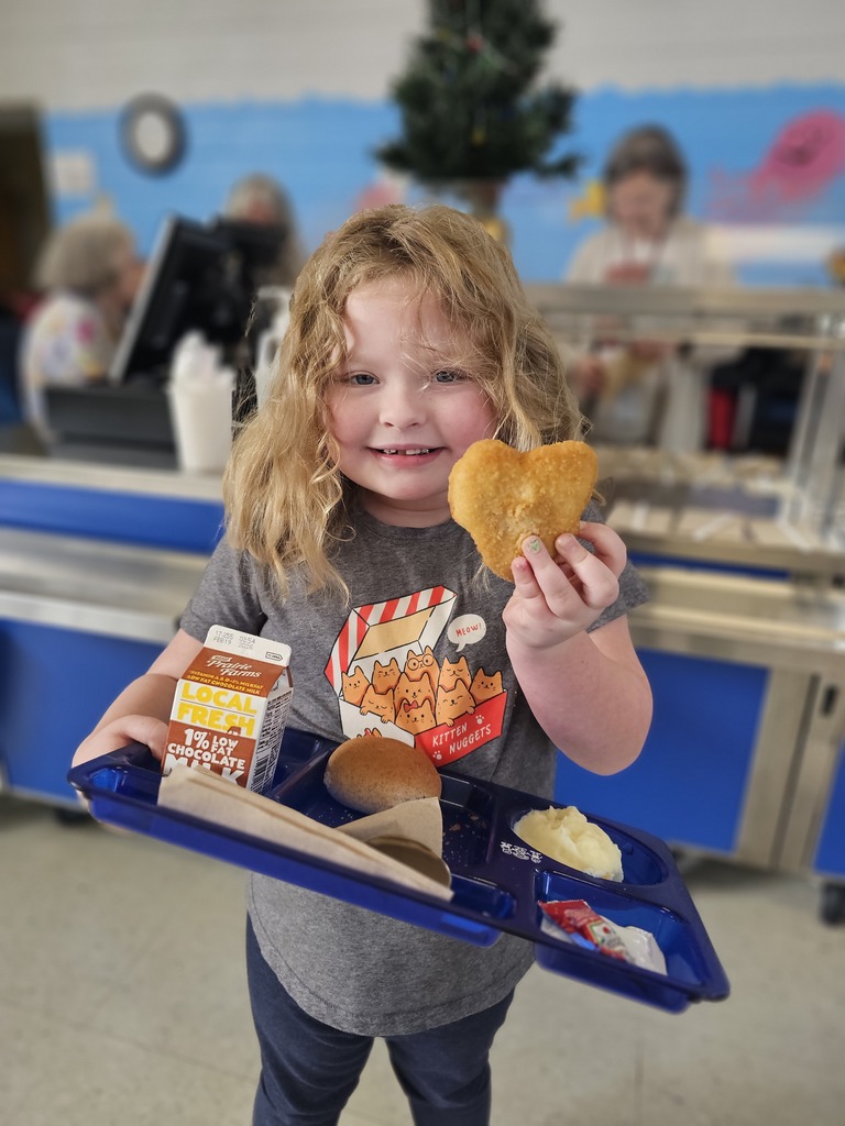 wcp student holding chicken shaped like a heart.