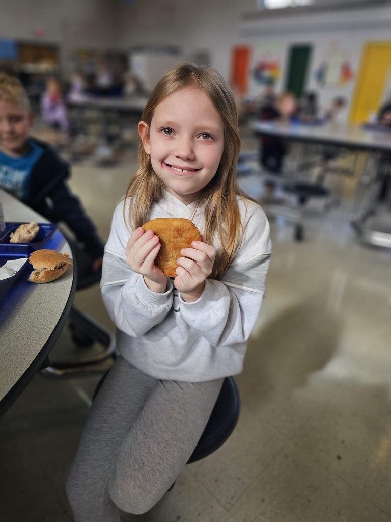 wcp student holding chicken shaped like a heart.