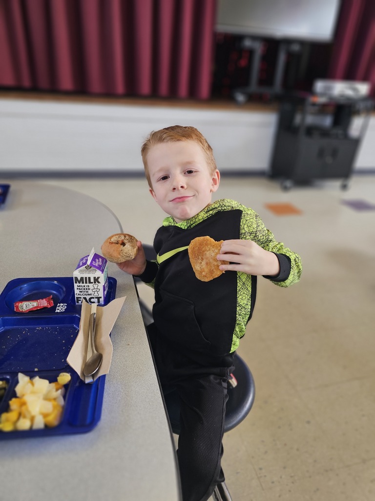 wcp student holding chicken shaped like a heart.