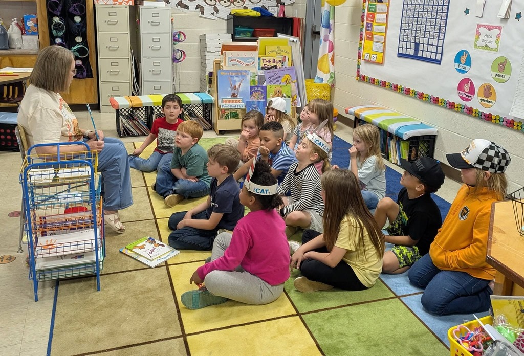 West Carroll Primary students listen as a guest speaker reads to them during Read Across America week