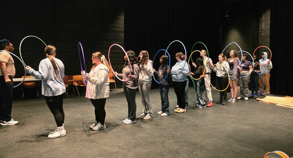 Students participating in team building activities with hullahoops