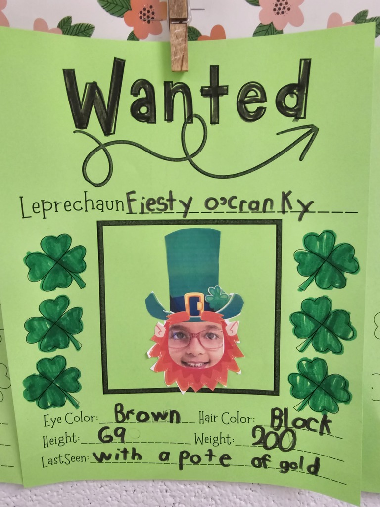 wcp student with leprechaun hat and beard for their own leprechaun writing page describing with adjectives and physical traits like eye color, hair, height, student writing illegible