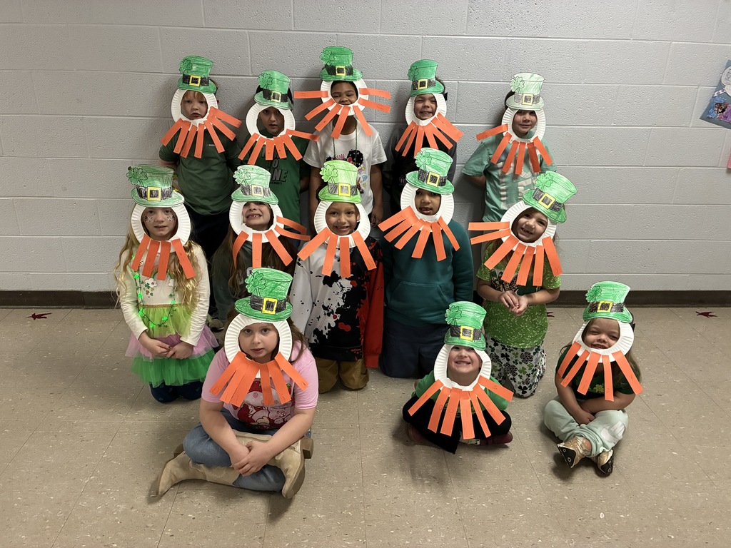 mrs sherry's students wearing leprechaun masks made from constructin paper