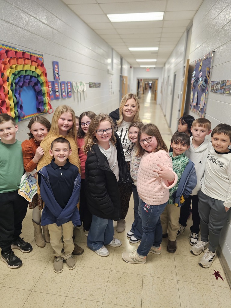 mrs elizabeth with former students now in second grade all smiles