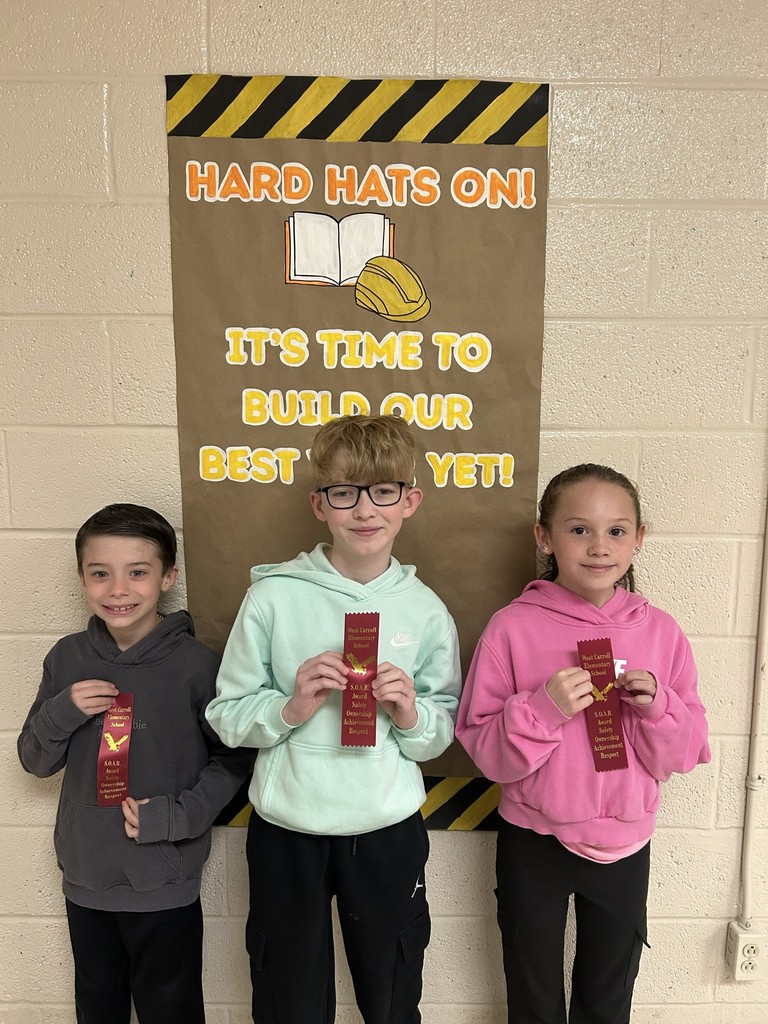 West Carroll Elementary students holding ribbons earned for week 19 and 20 SOAR Award, three students smiling