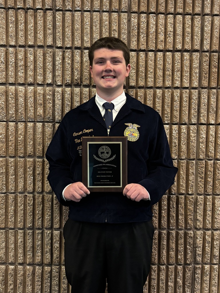 Carson Cooper with the Tennessee FFA Association award for Beef Production 