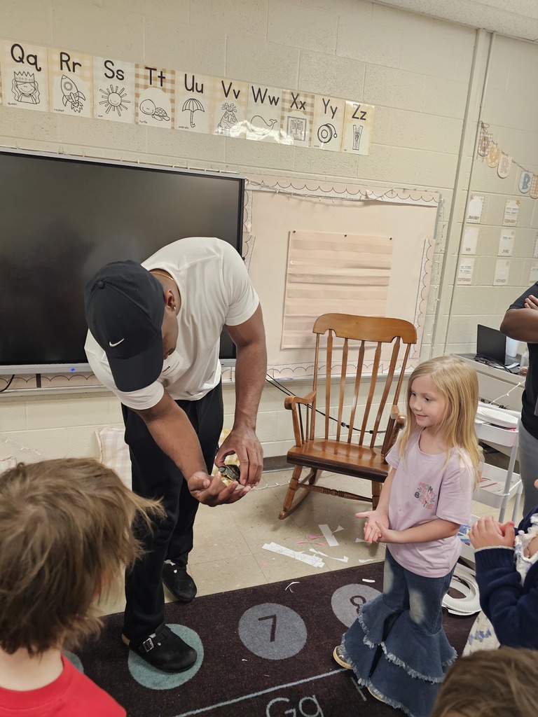 ms taolers class learning about turtle student holding turtle