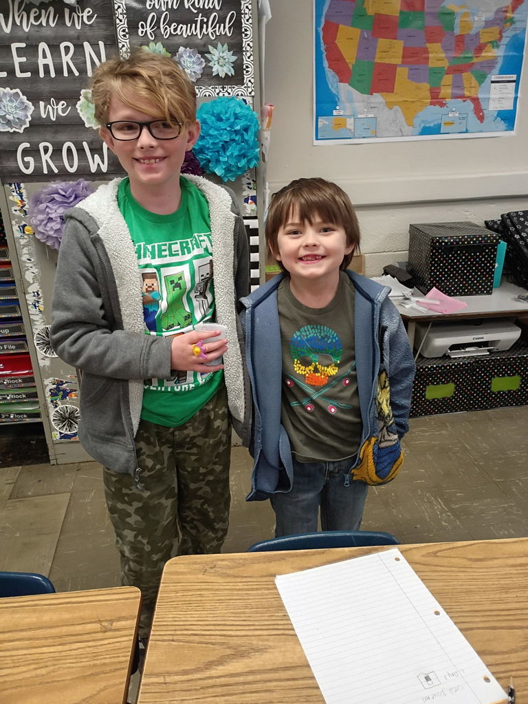 west carroll students holding cups of soil and seeds as they begin learning about plants