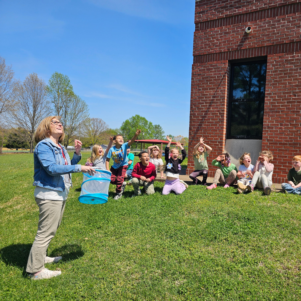 west carroll primary students working outside with butterfly project and teacher mrs sherry