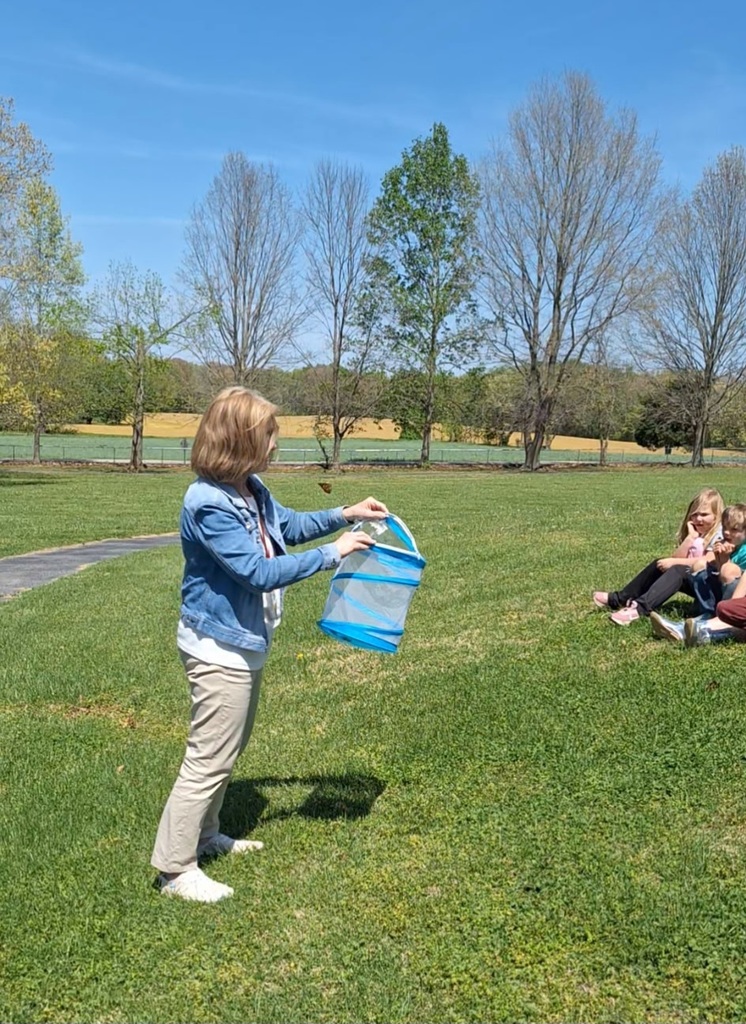 west carroll primary students working outside with butterfly project and teacher mrs sherry