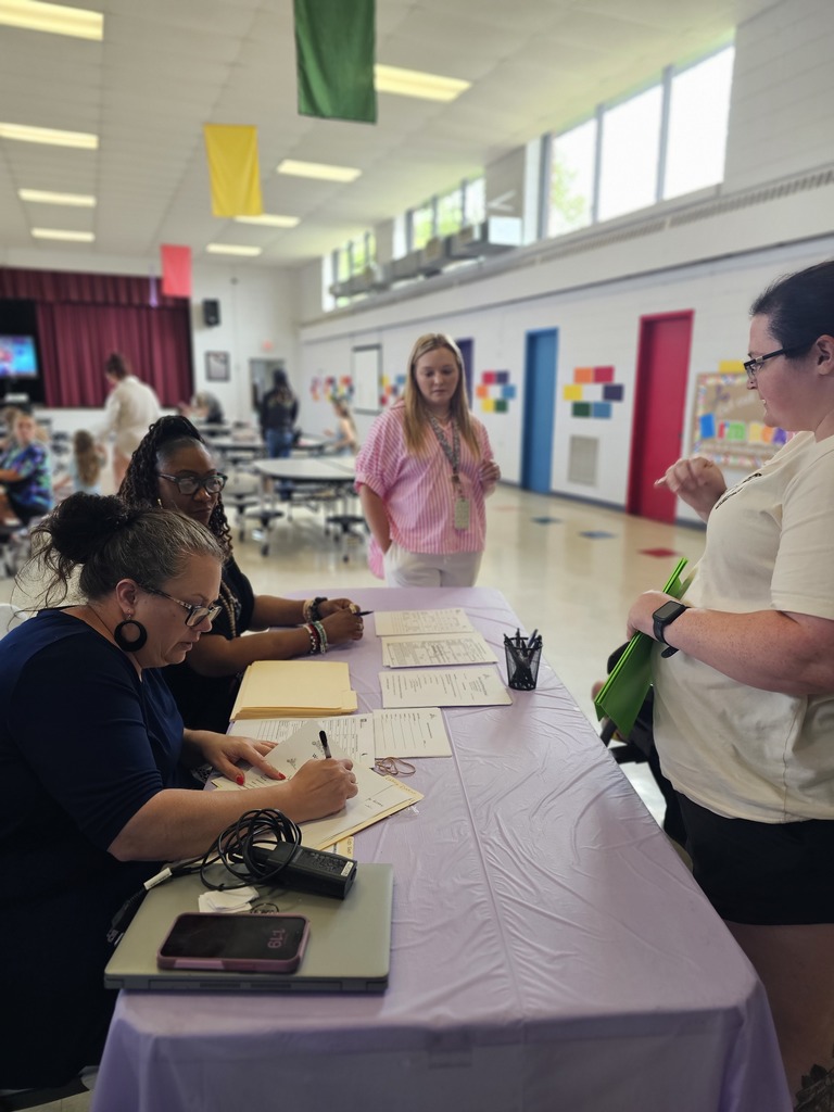 west carroll primary registration welcome table with school staff and parent