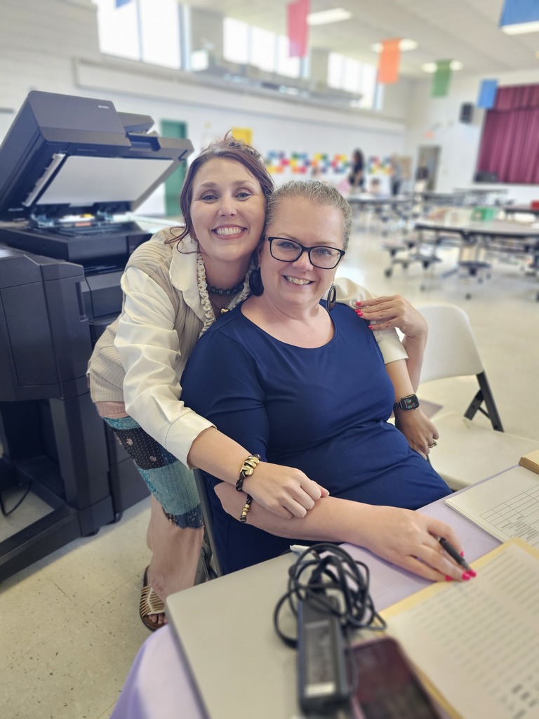 two wc employees posing while getting ready for registration