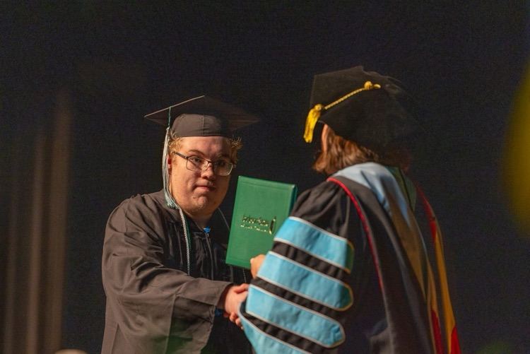 Braden Joyner receiving diploma