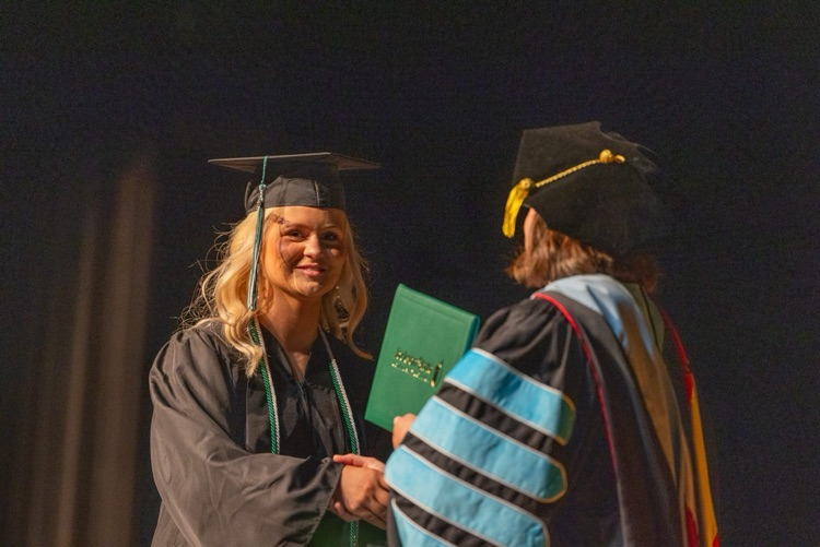 Britni Shepherd receiving diploma
