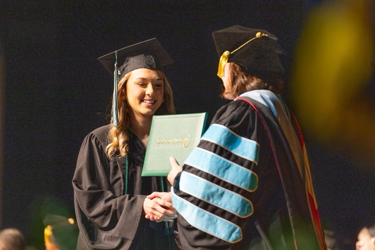 Hannah Pinson receiving diploma