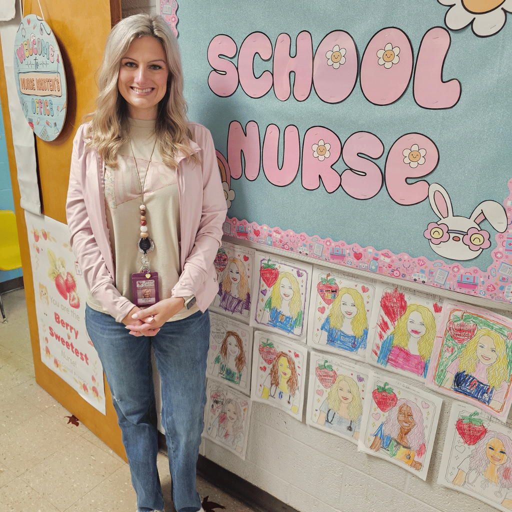 wcp school nurse standing by photos colored by students