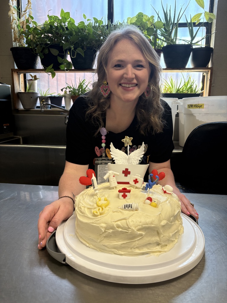 wces school nurse shows off her specailly decorated cake from the school employees