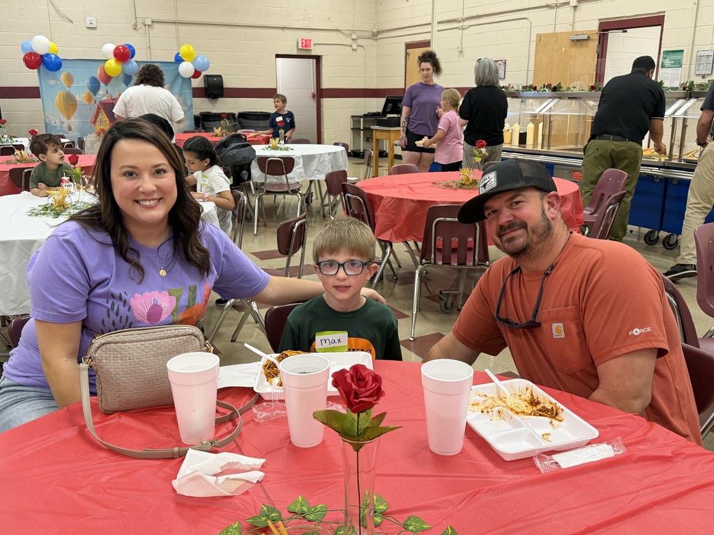 family of wcp 2nd grader poses during spaghetti dinner