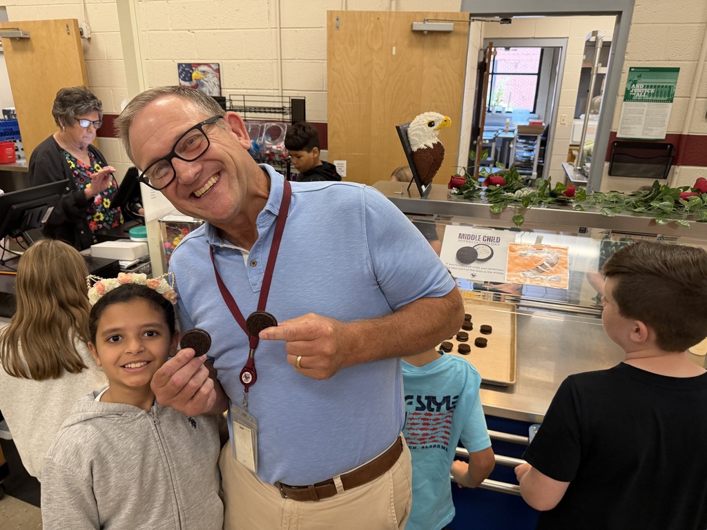 director of schools standing with student on national middle child day oreo day
