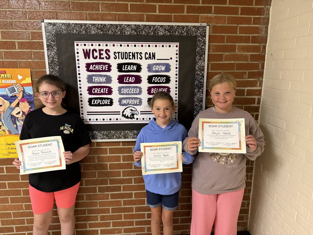 three of west carroll elementary school's students posing with certificates as recipients of this montyh's SOAR student