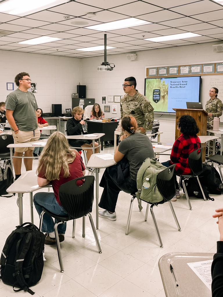 Staff Sergeant Edward Humphries and Private First-Class Emily Humphries of the Tennessee Army National Guard with students in class 