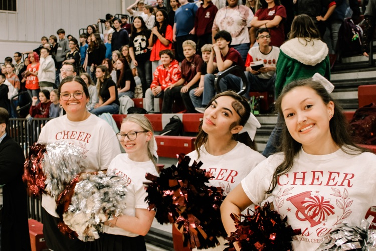 Photos from pep rally featuring cheering student body in the high school gym. 