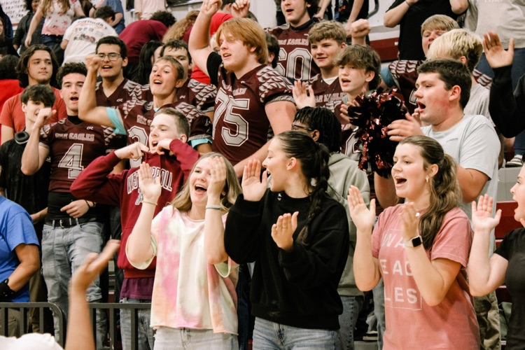 Photos from pep rally featuring cheering student body in the high school gym. 