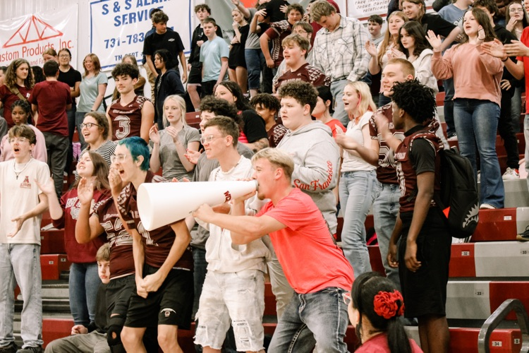 Photos from pep rally featuring cheering student body in the high school gym. 