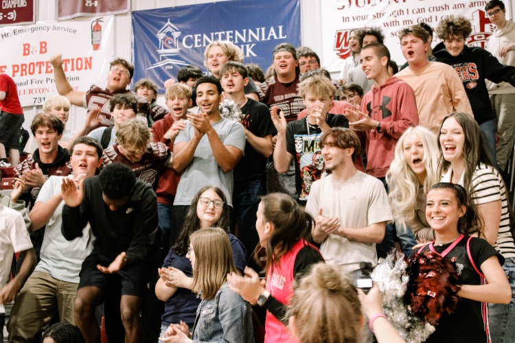 Photos from pep rally featuring cheering student body in the high school gym. 