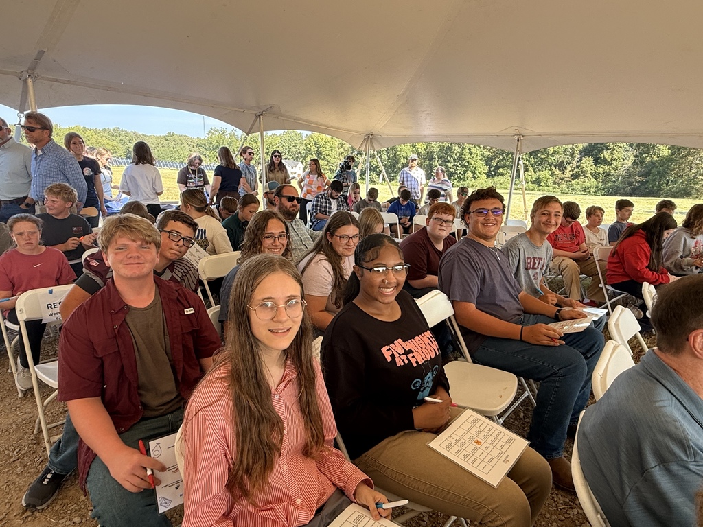 West Carroll students sit together under an event tent during the Trezevant Solar Farm Flip the Switch event, where they joined community members and industry representatives for the facility’s opening celebration.