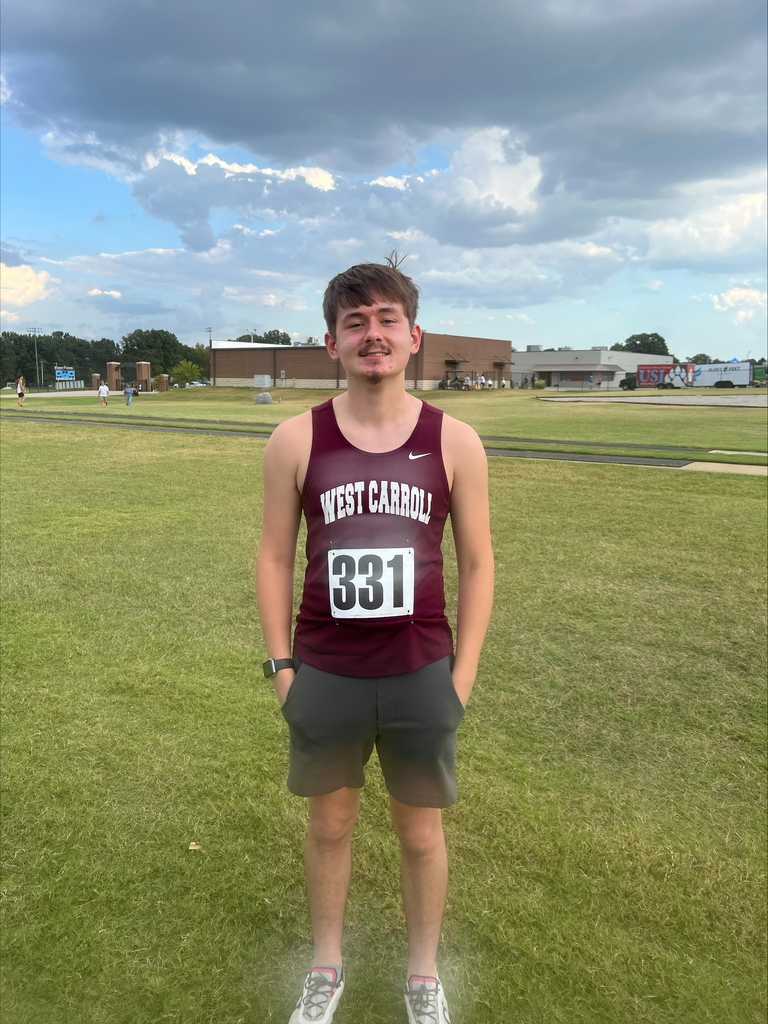 West Carroll cross country athelete posing after match