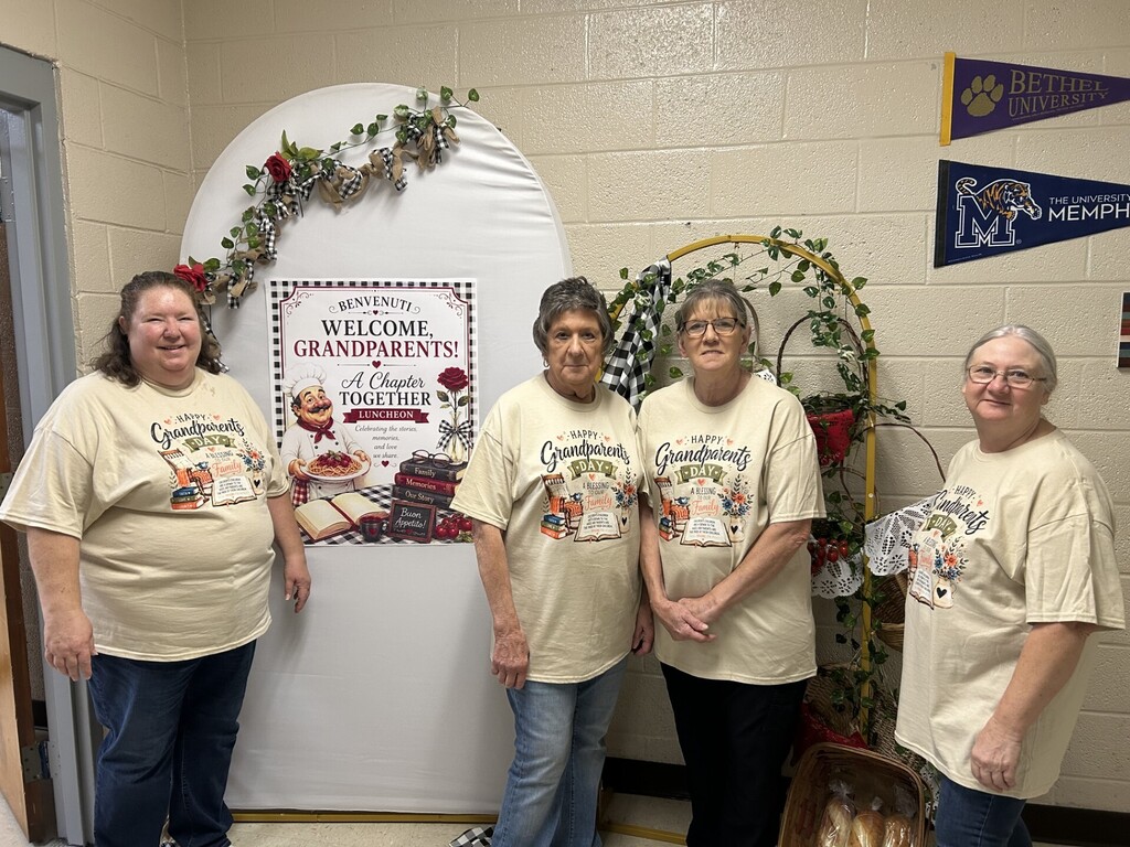 lunch ladies before grandparents day posing in hall by arches