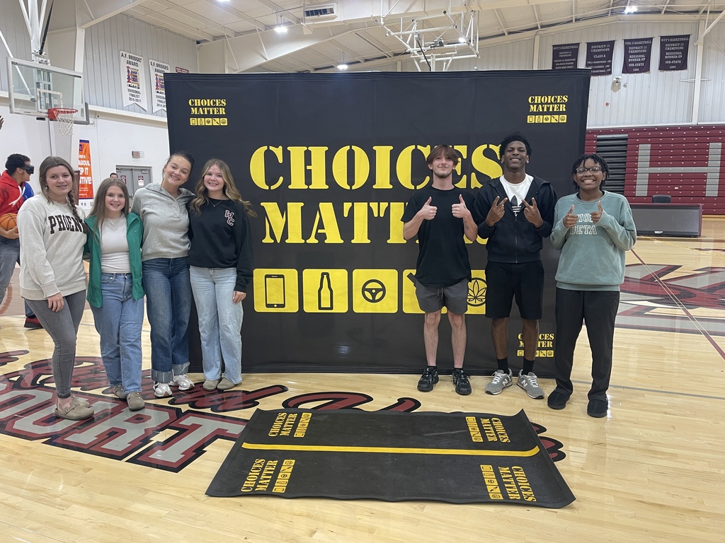 est Carroll students pose together in front of the Choices Matter display following a presentation and hands-on activities focused on the consequences of impaired and unsafe driving.