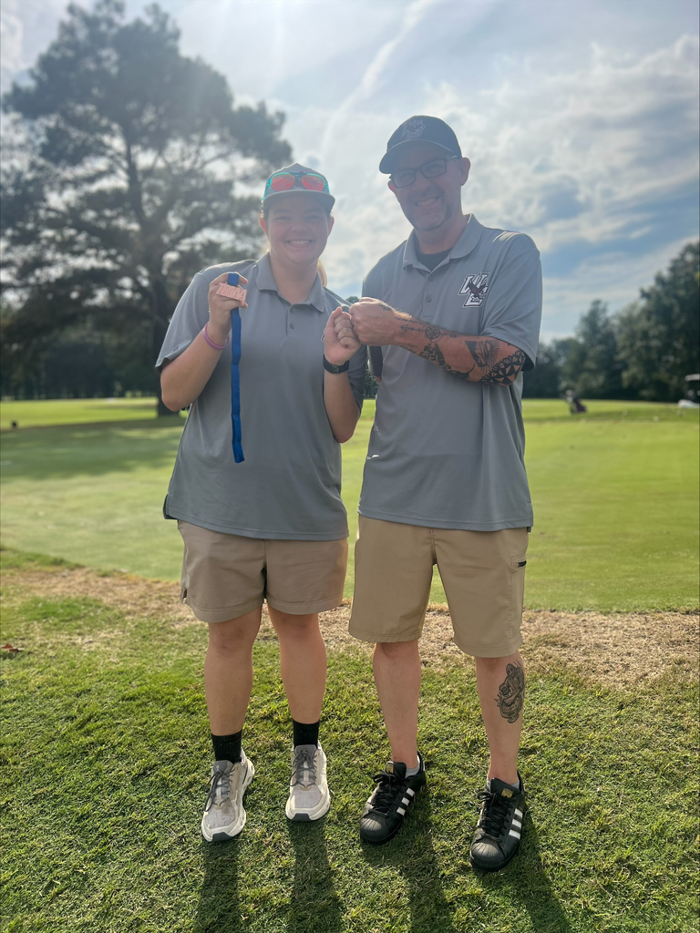Mackenzie Finley posing with her coach after earning a fourth-place finish and regional tournament spot