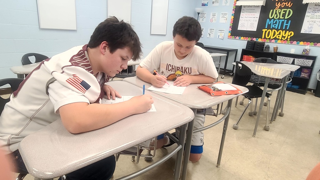 west carroll 6th grade students working in math class on community planning activity to calculat distance