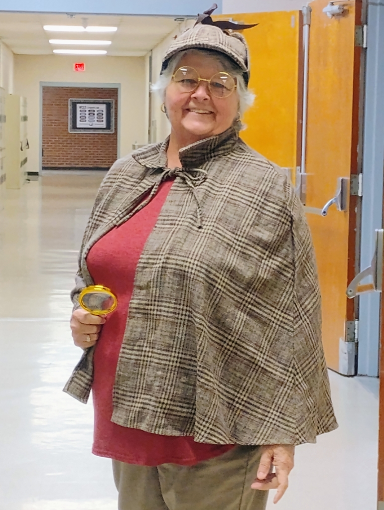 mrs pat hudgins poses as a detective for the reading celebration