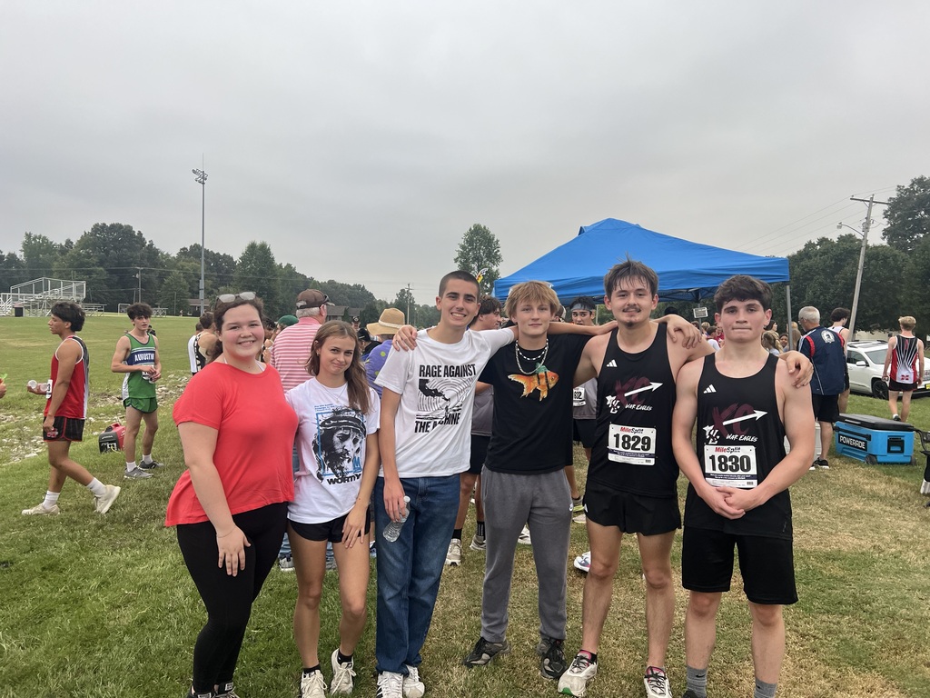 west carroll student competing at cross country meet with class peers cheering them on