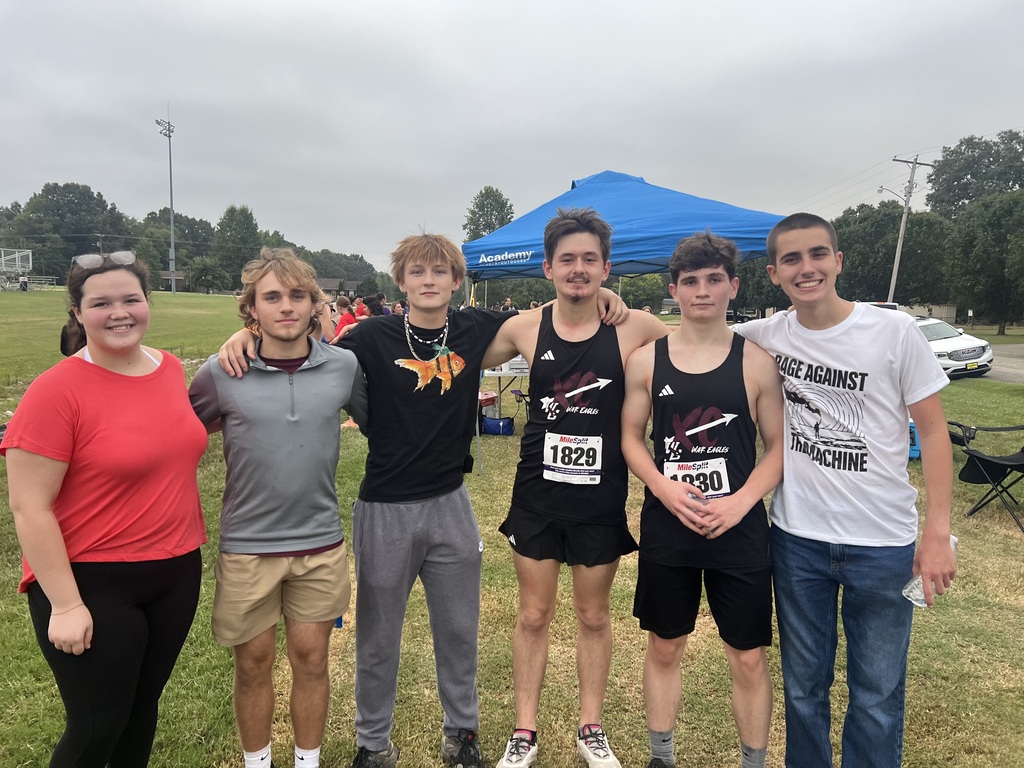 west carroll student competing at cross country meet with class peers cheering them on