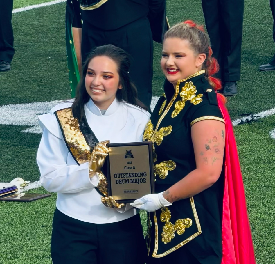 west carroll drum major accepting award from former frum major who is now drum major for bethel university