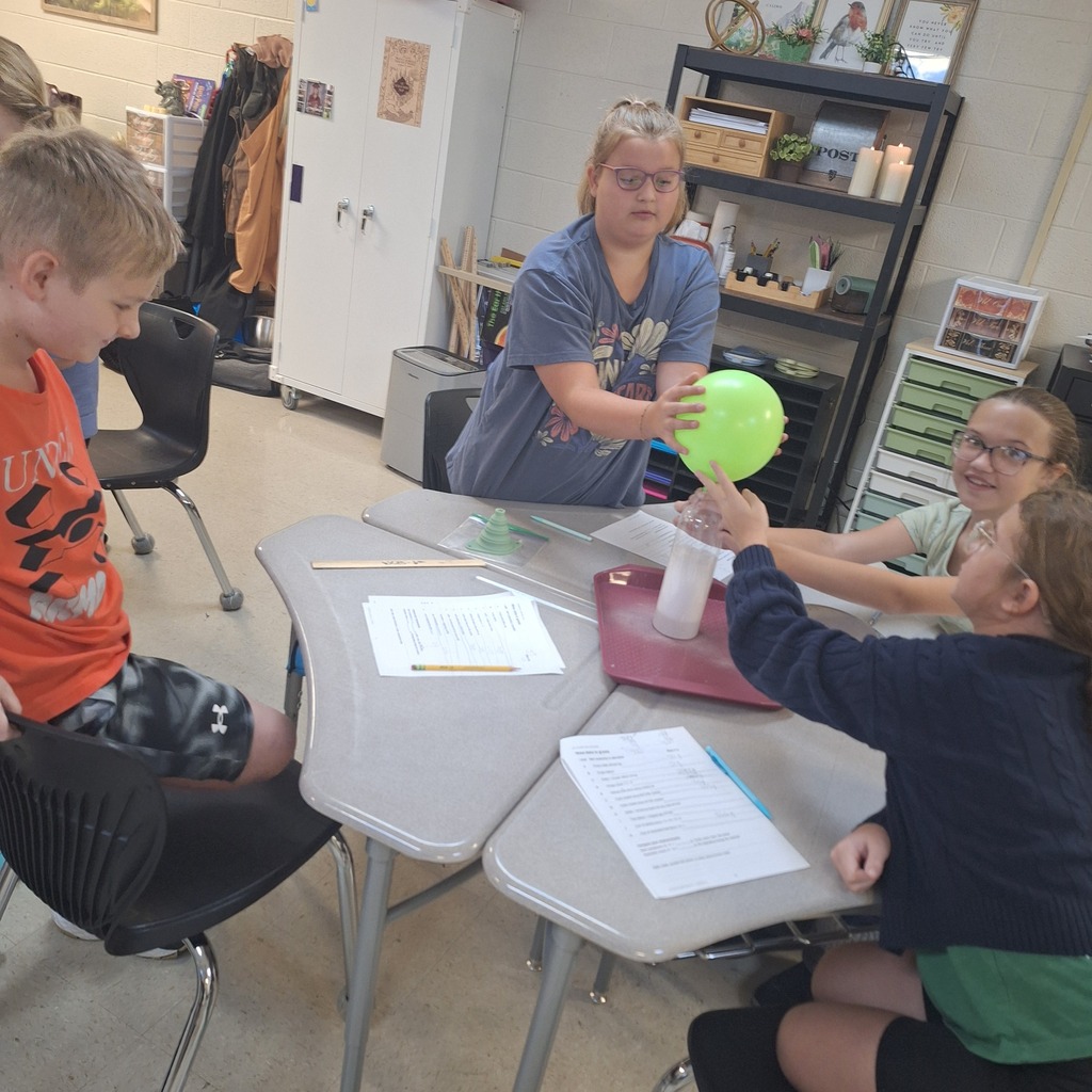 west carroll elementary students performing science experiment about mass conservation