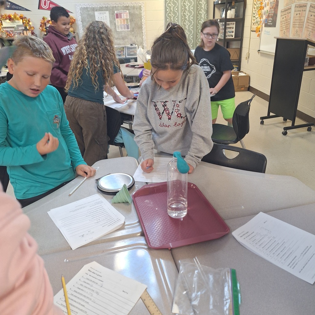 west carroll elementary students performing science experiment about mass conservation