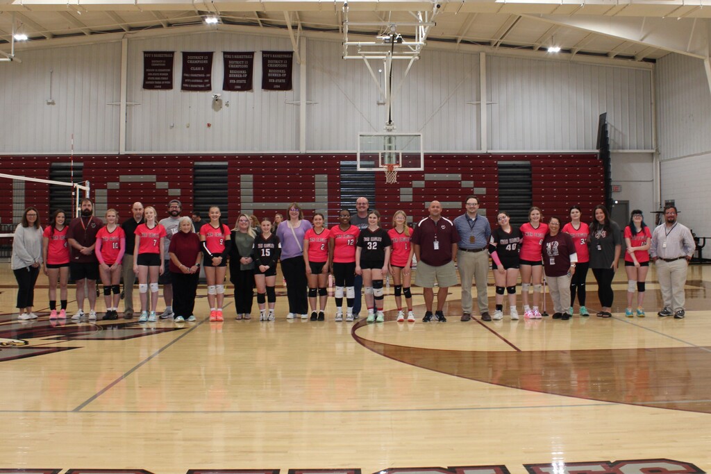 West Carroll volleyball players stand alongside the teachers they selected to recognize during Teacher Appreciation Night in the West Carroll gym.