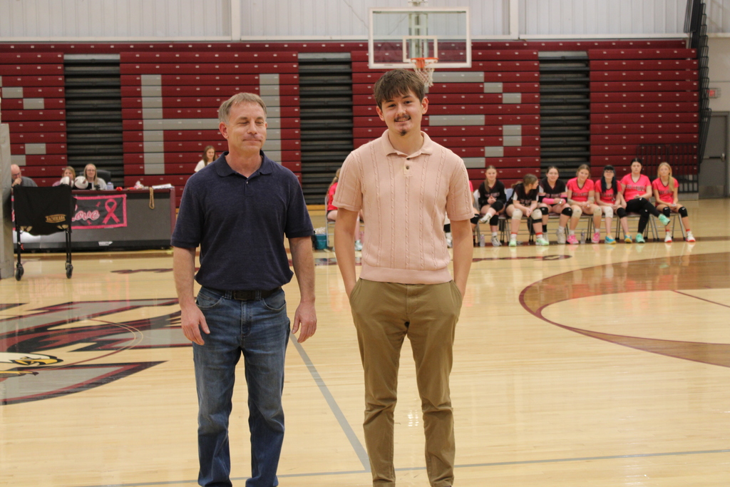 A West Carroll senior athlete stands with family members on the court during Senior Night festivities.