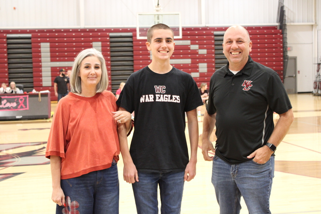 A West Carroll senior athlete stands with family members on the court during Senior Night festivities.